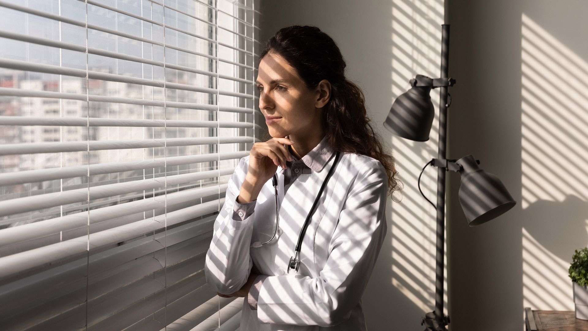 A doctor is looking out of a window
