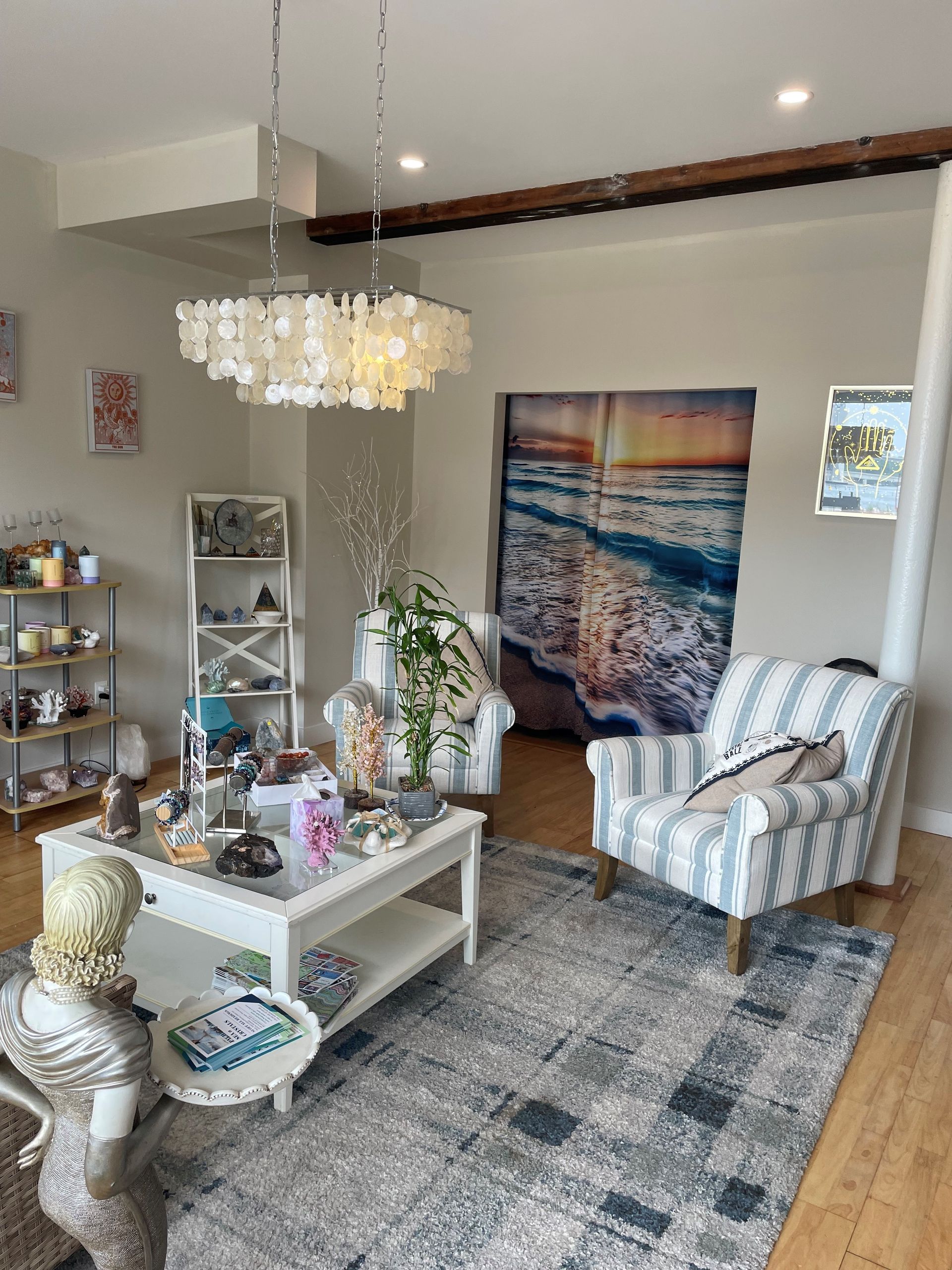 A living room with a couch , chair , coffee table and rug.