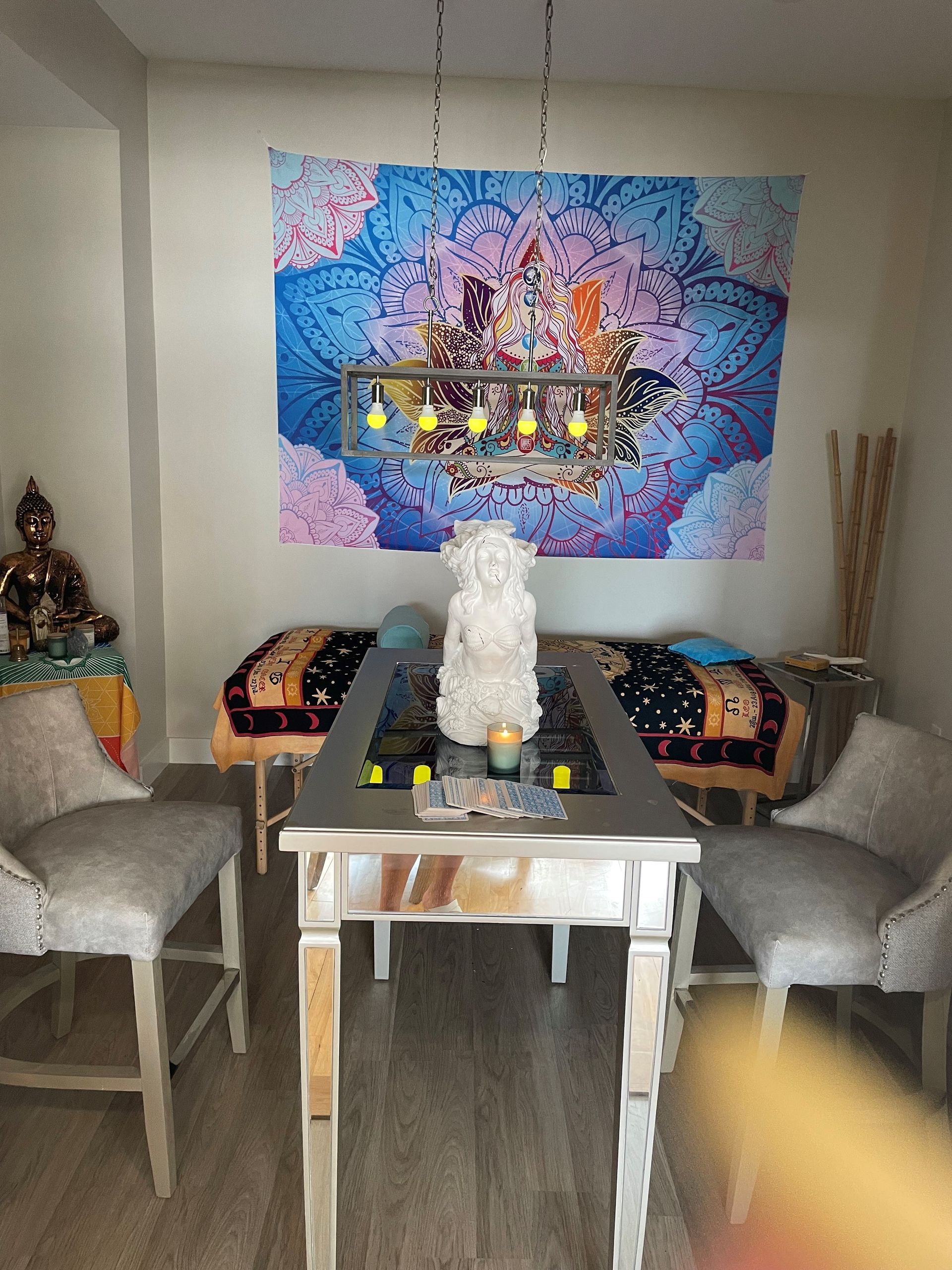 A dining room with a table , chairs and a chandelier.