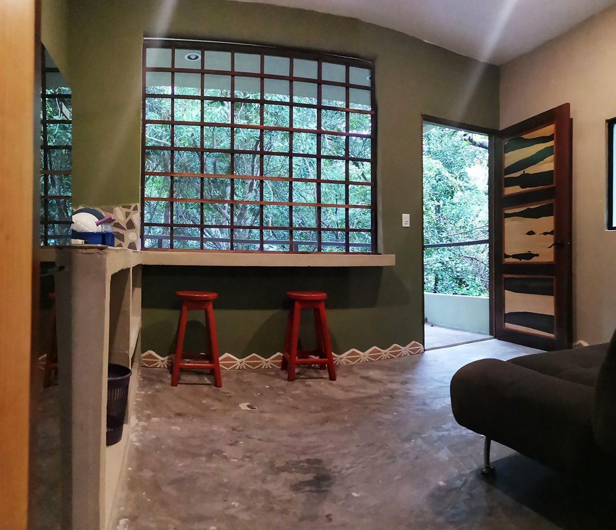 A living room with a couch and two red stools