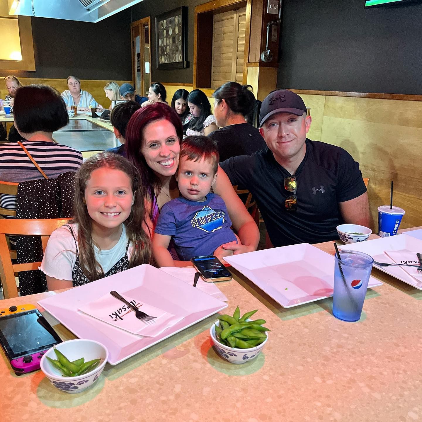 A family of 4 posing for a picture at desaki