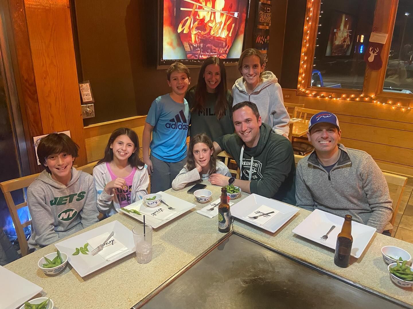 A group of people are sitting at a table in desaki