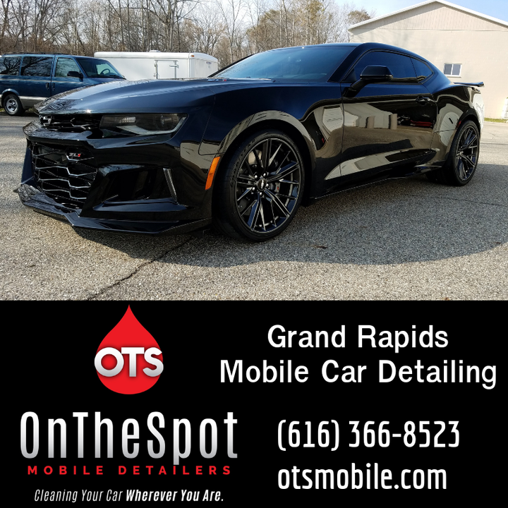 An advertisement for on the spot mobile detailers shows a black car