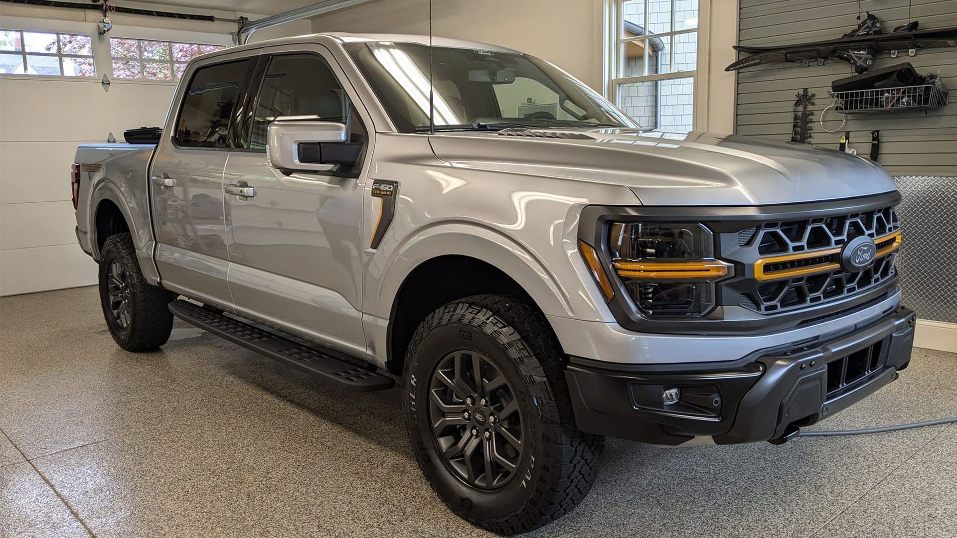 A bottle of oil is sitting on a kitchen counter next to a gas stove.