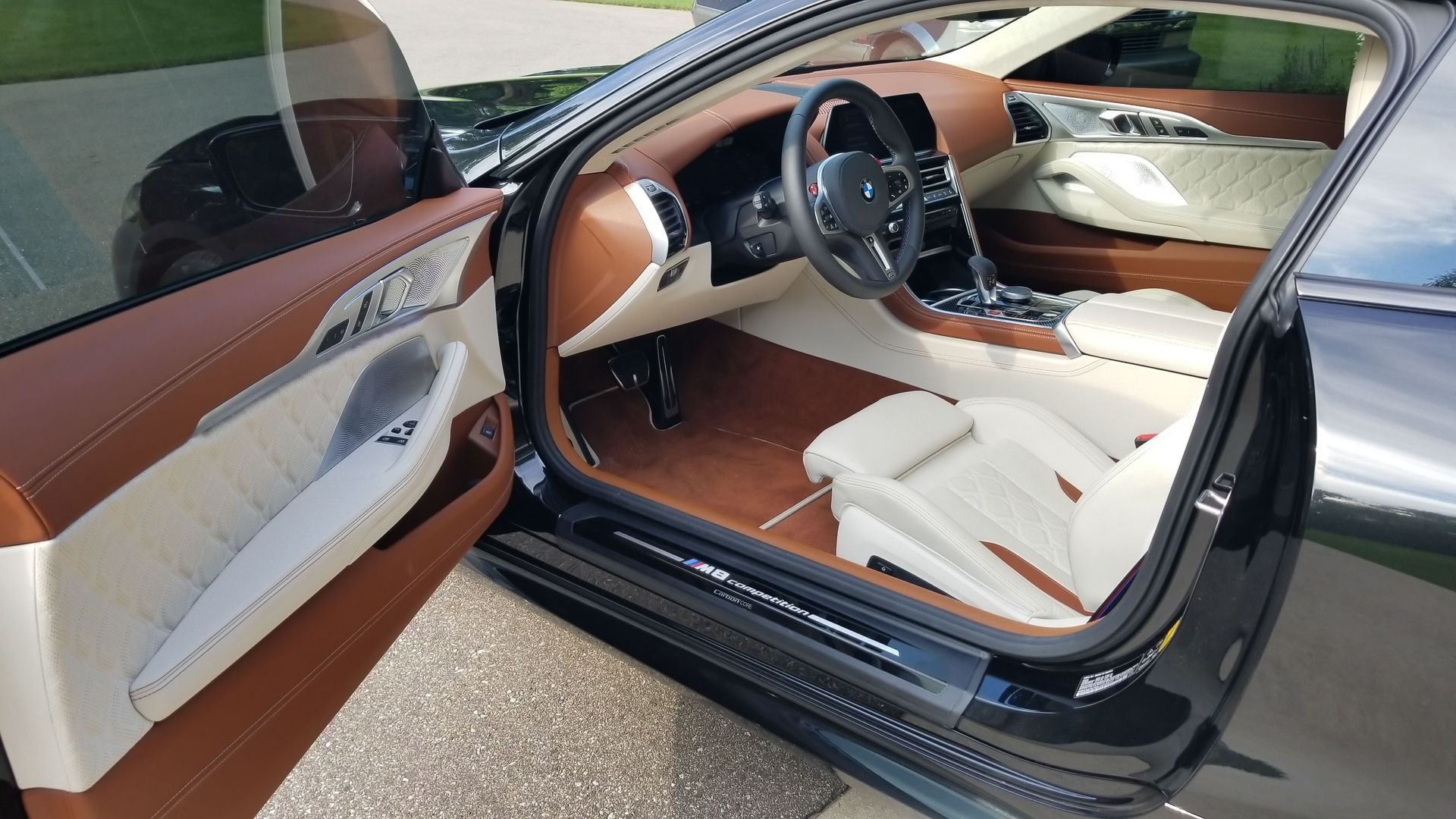 The interior of a black car with the door open