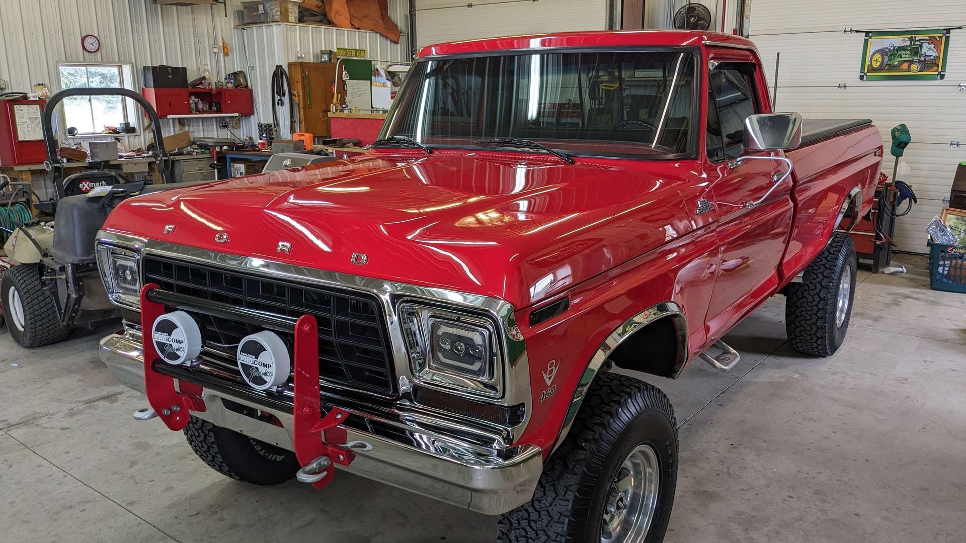 A red pickup truck is parked in a garage.