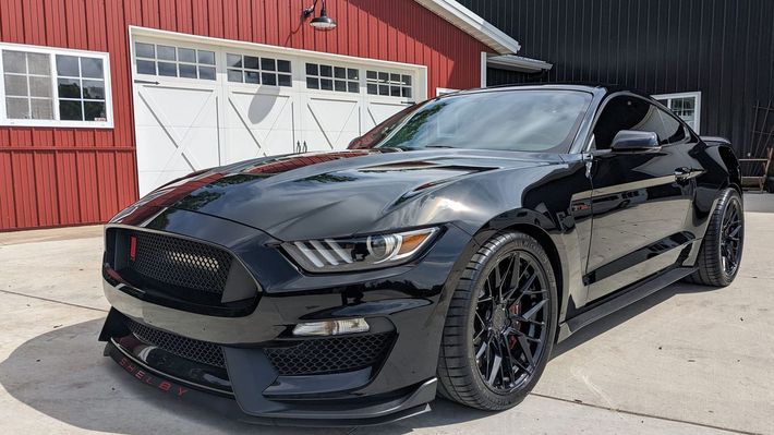 The interior of a car with a dashboard and steering wheel