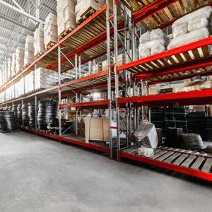 Warehouse industrial goods. Large long racks. Cardboard boxes and coiled plastic tube. Toning the image.