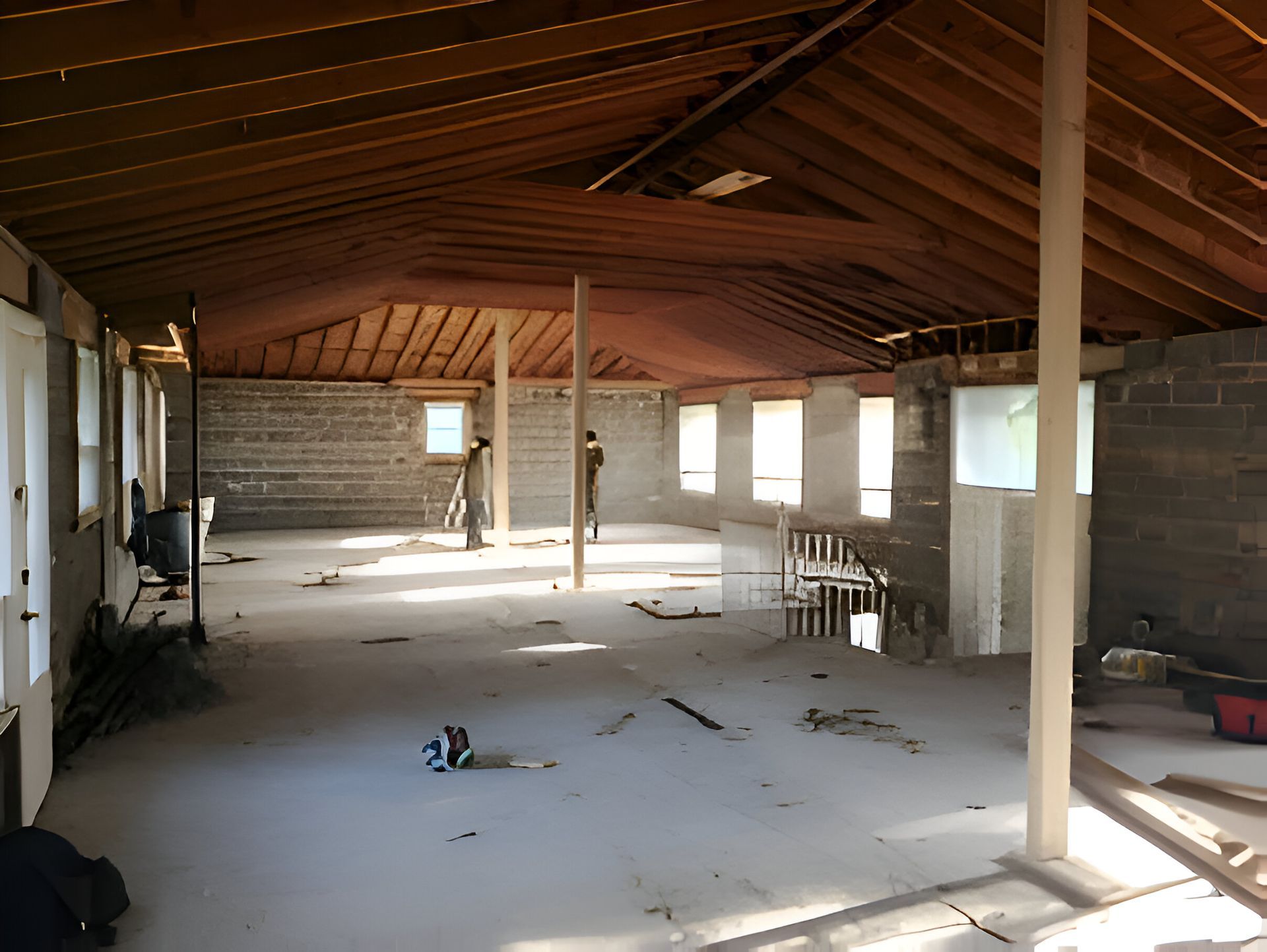 An empty room with a wooden ceiling and a lot of windows