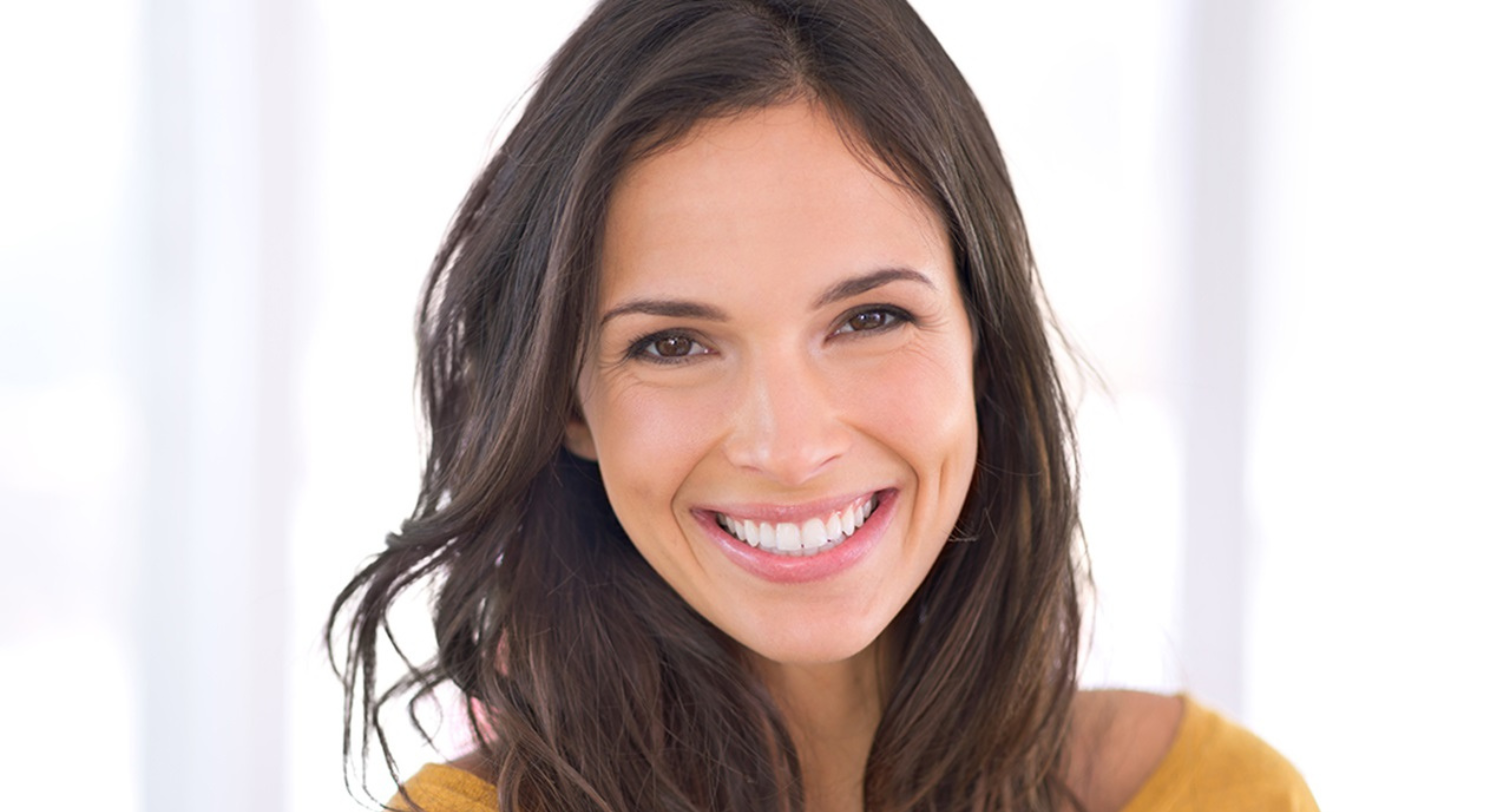 woman smiling, looking at the camera