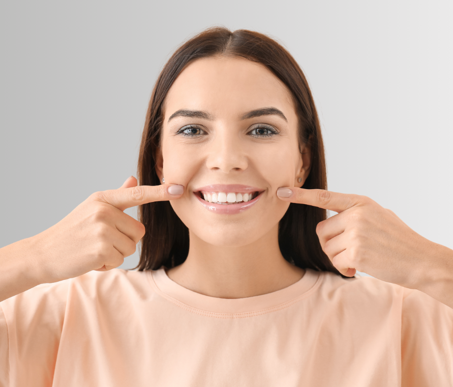 Woman pointing to her smile