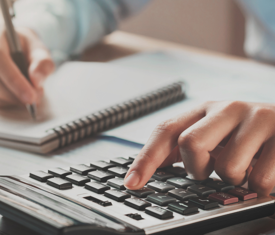 Person using a calculator and taking notes