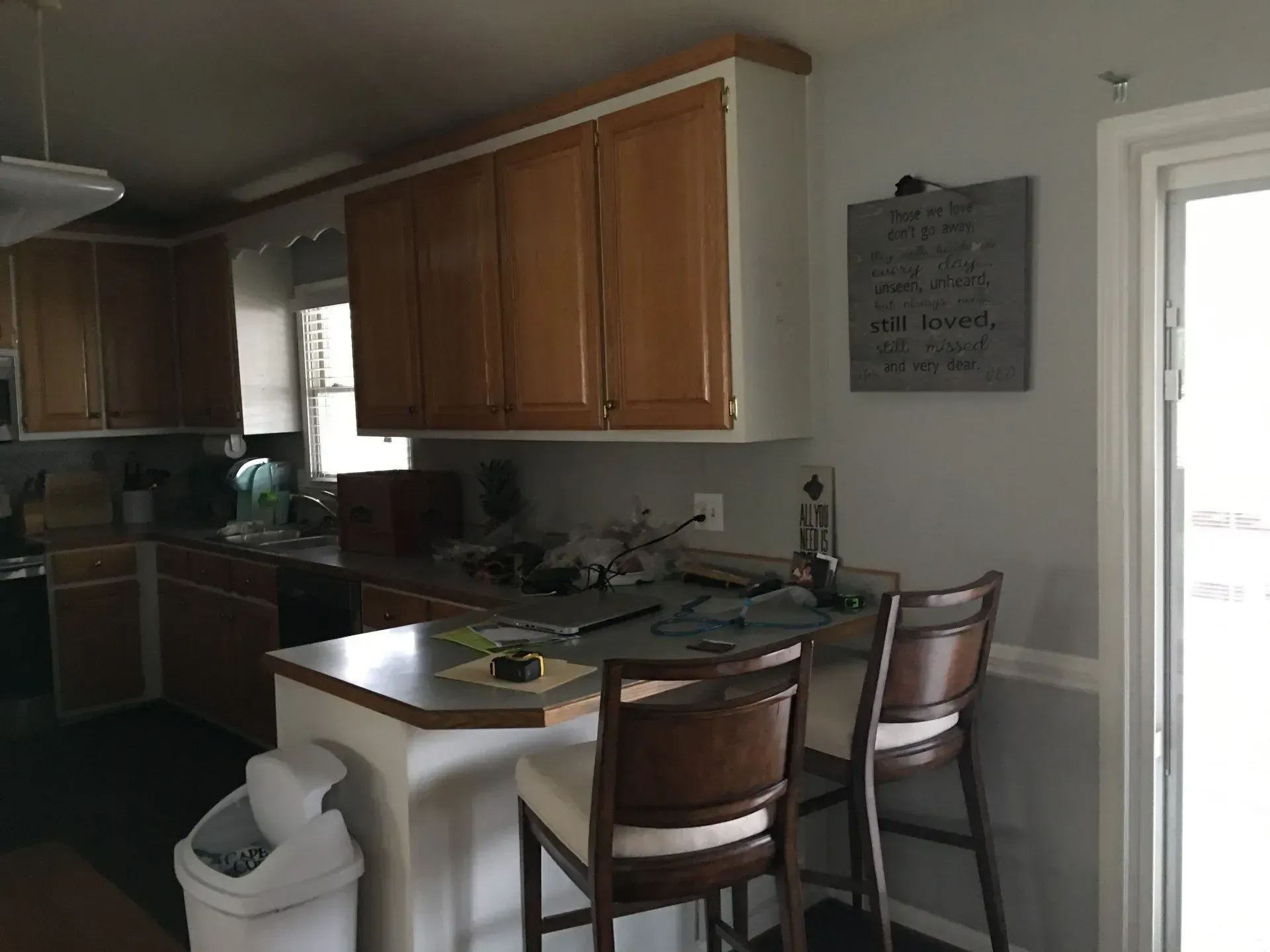 A kitchen with a sign on the wall that says