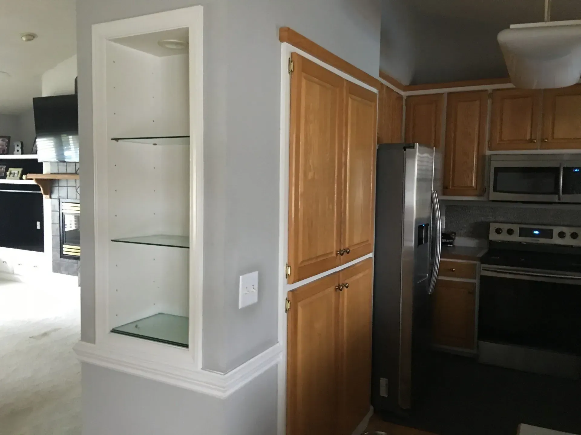 A kitchen with stainless steel appliances and wooden cabinets