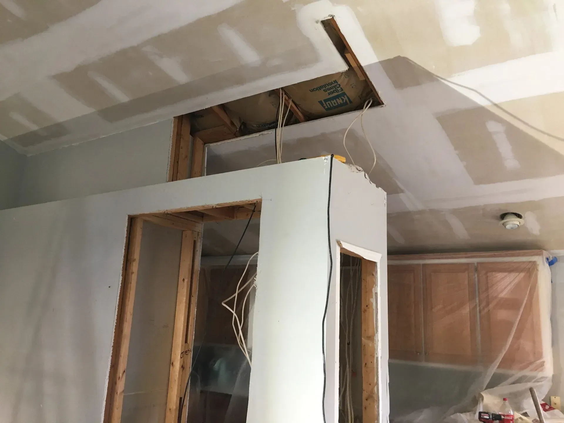 A room that is being remodeled with a hole in the ceiling