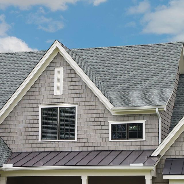 A house with a gray roof and white trim