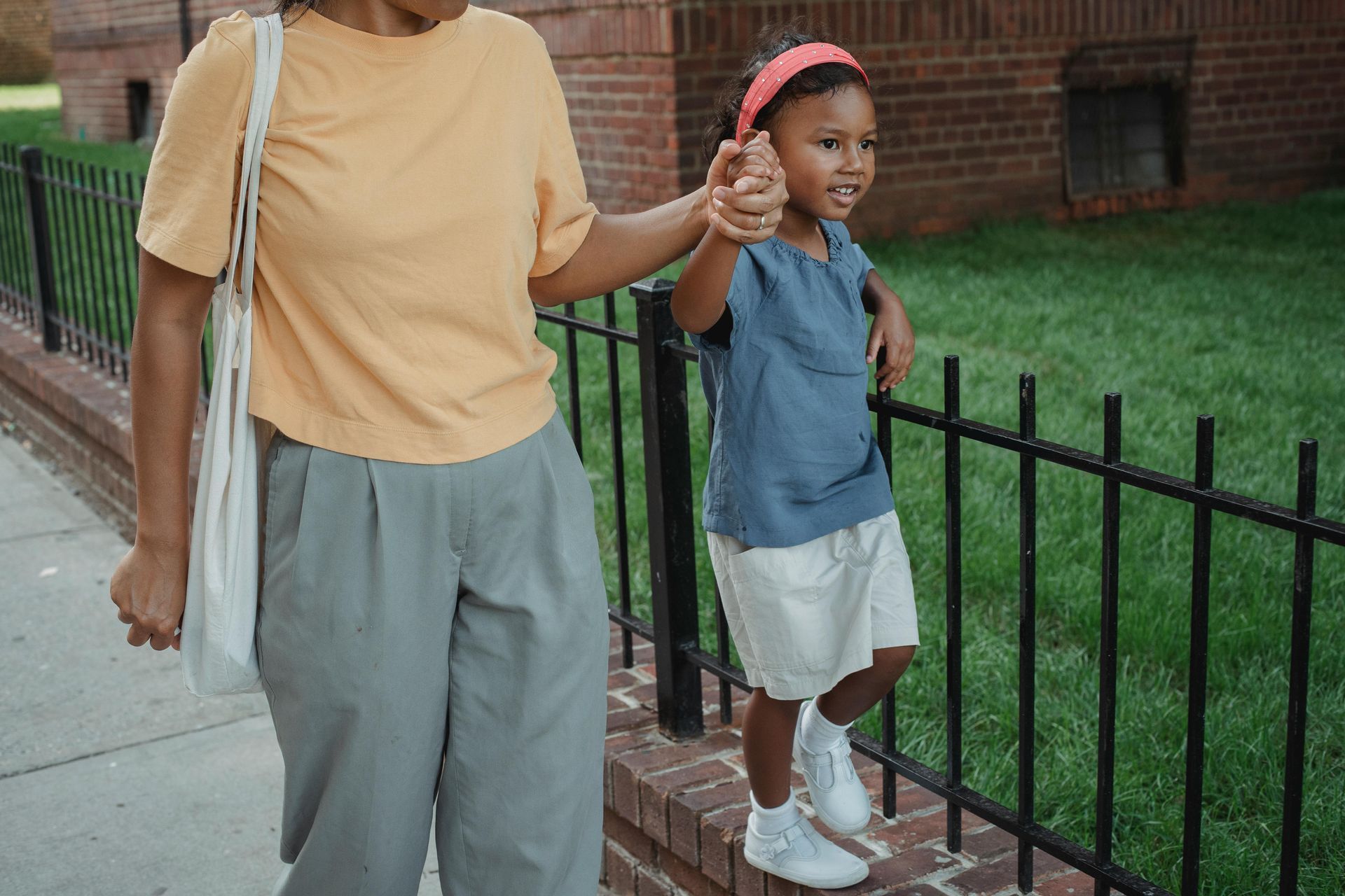 A lawyer works at a desk featuring wooden family figurines, a gavel, and a scale of justice.