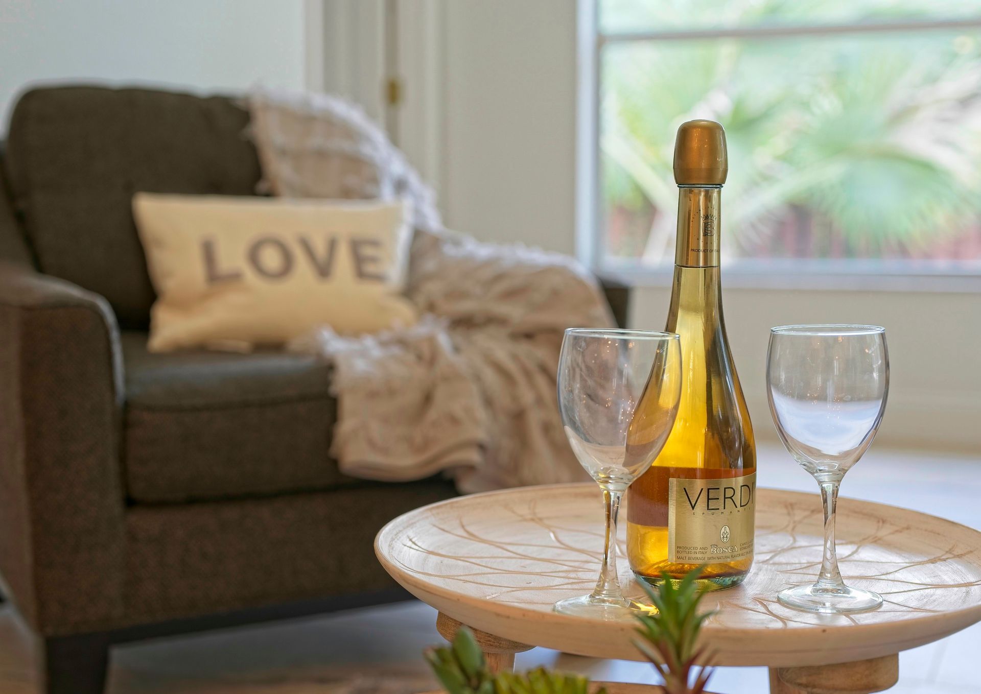 Bed with tray set for tea; teapot, cups, and pillows in shades of blue and white.