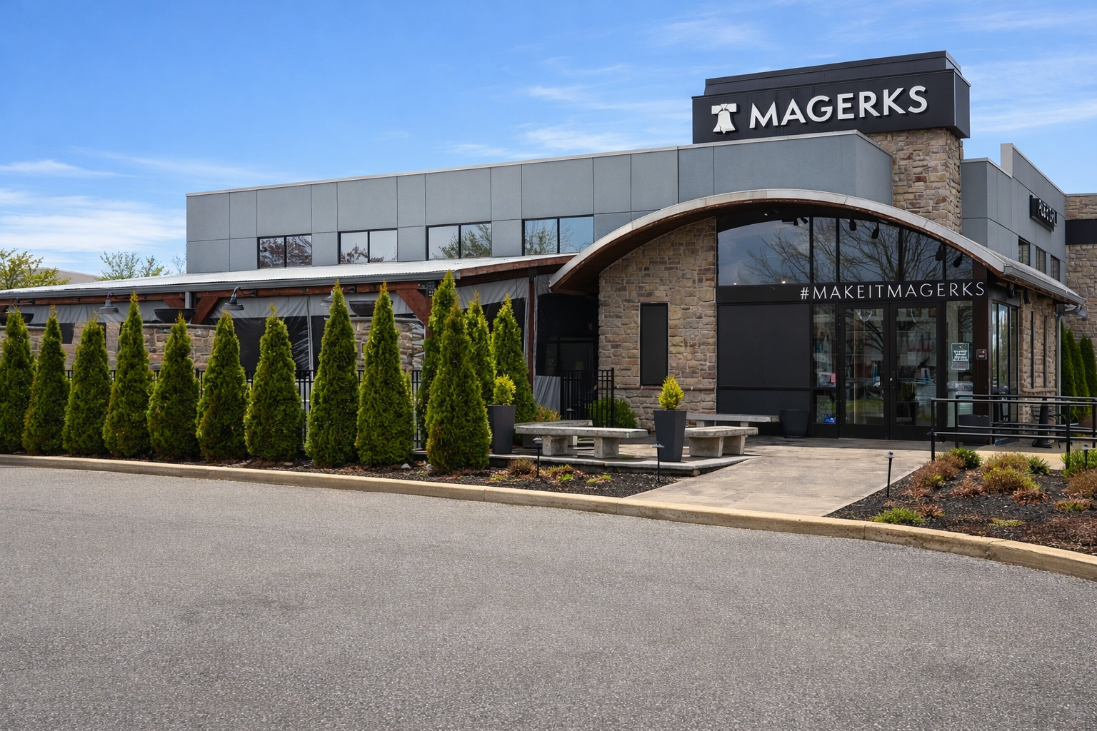 Interior of a crowded sports bar with tables, bar seating, TV screens, and servers carrying food.