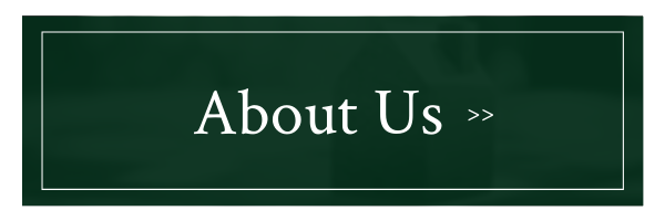 Dark green “About Us »” navigation button with white text and border