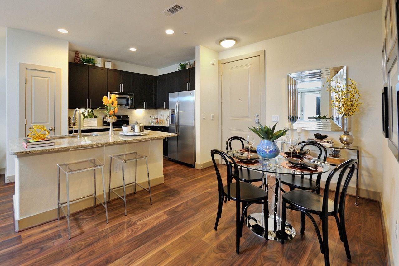 Open-concept kitchen and dining area with island and stainless appliances.