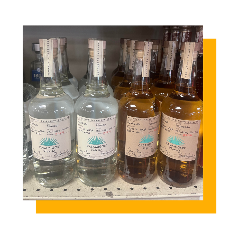 Bottles of tequila on a shelf; some clear, some amber-colored.