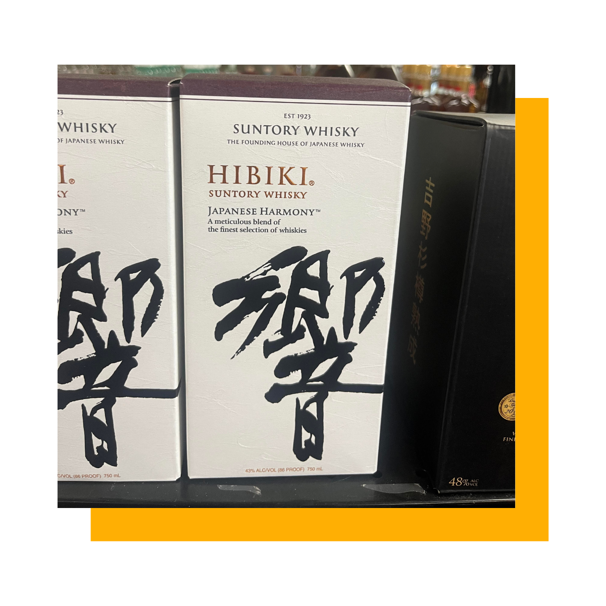 Boxes of Hibiki Japanese whisky with Japanese characters on a shelf.