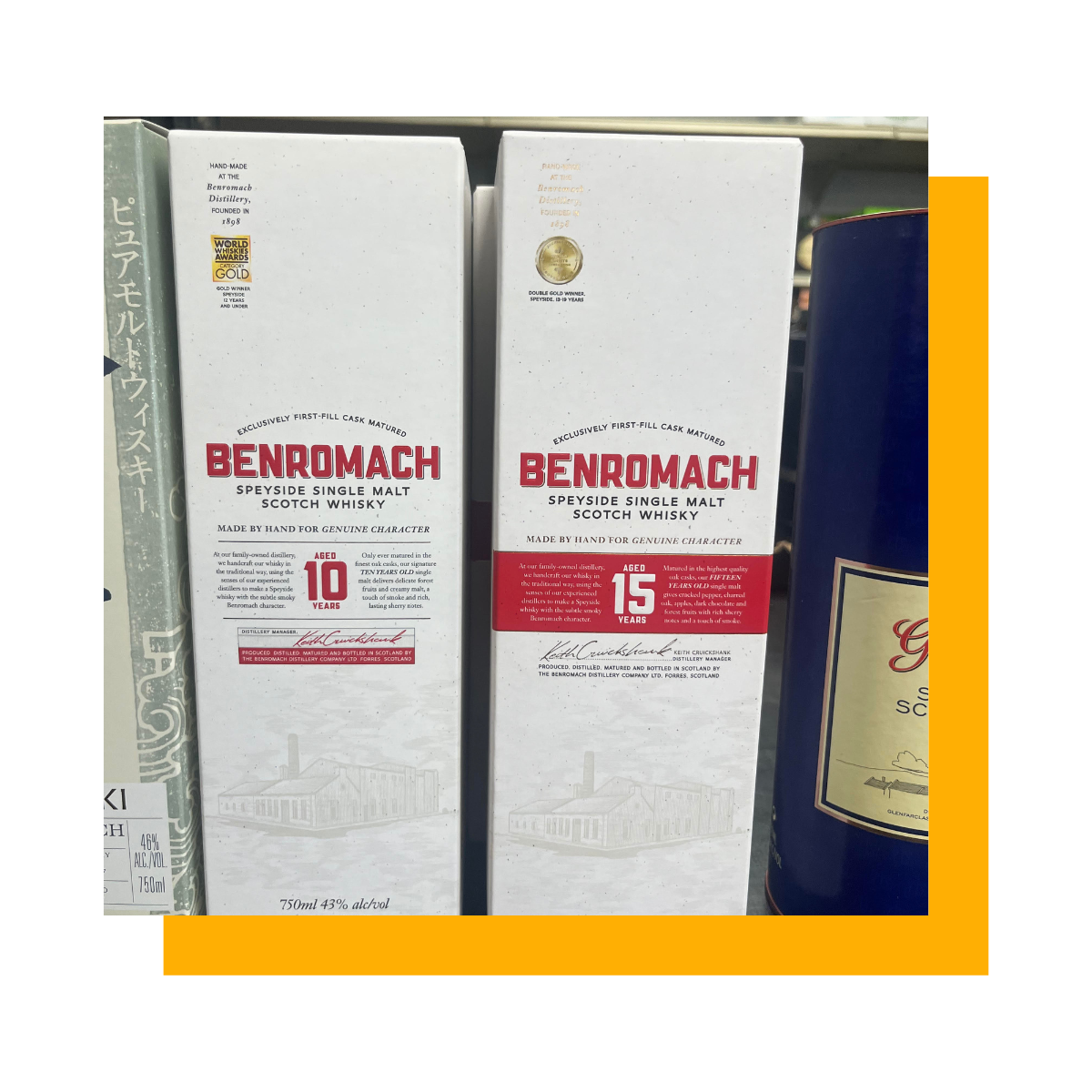 Two white Benromach whisky boxes, 10 and 15 year, stand side-by-side with red lettering.