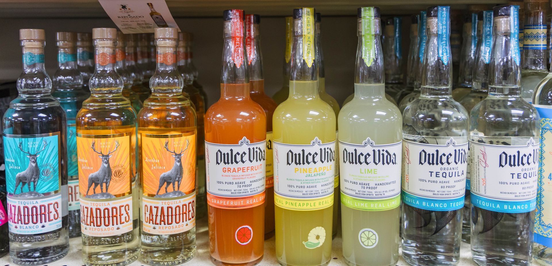 Liquor bottles on a shelf: Cazadores and Dulce Vida brands.