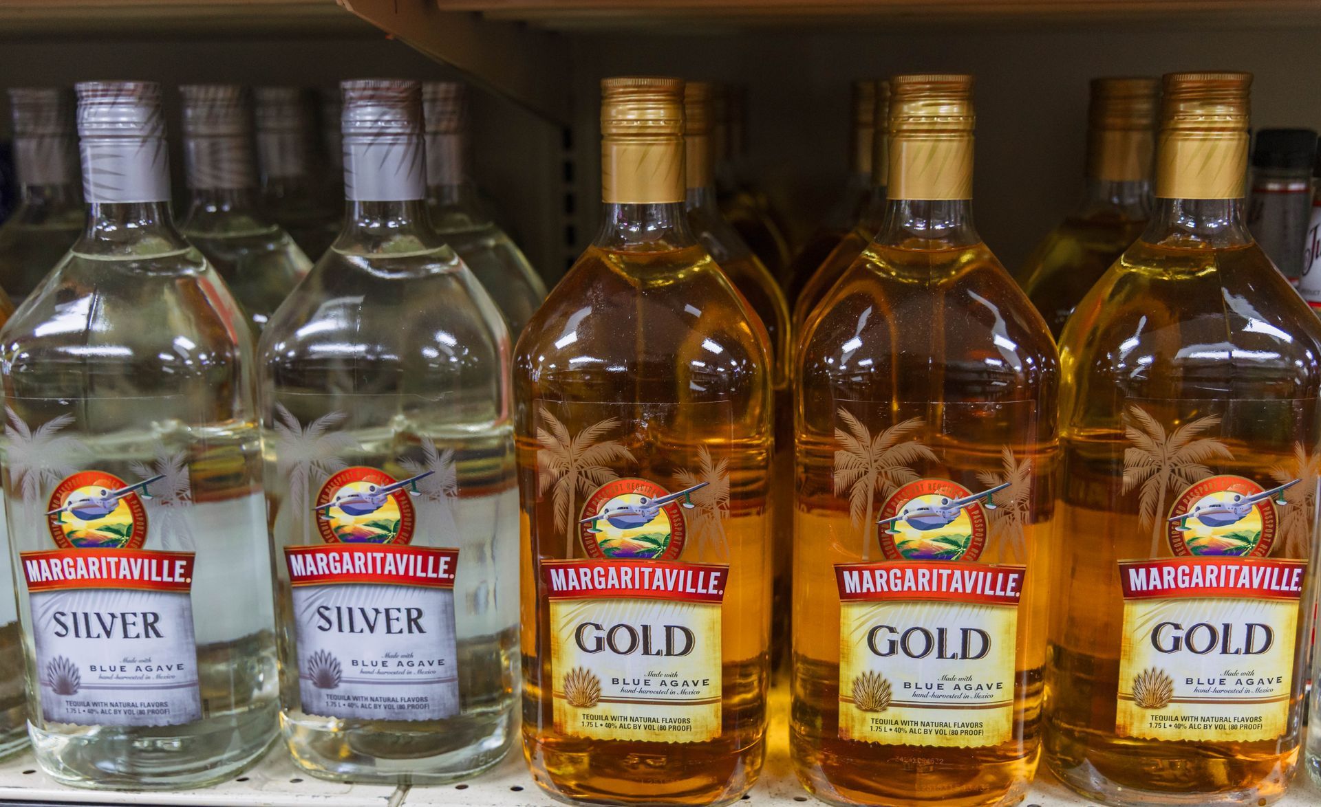 Bottles of Margaritaville Silver and Gold tequila on a store shelf.