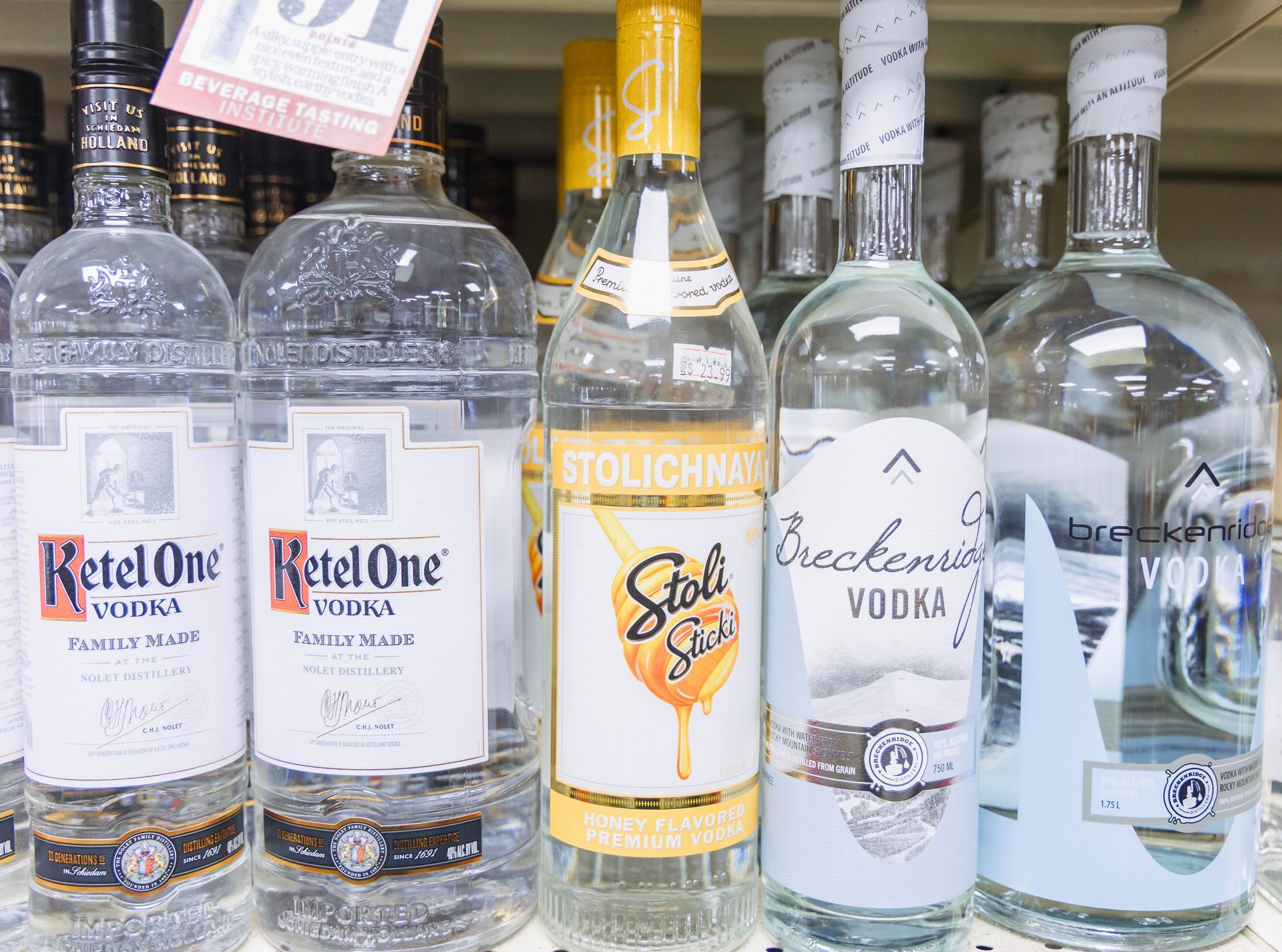 Bottles of vodka, including Ketel One and Stolichnaya, on a store shelf.