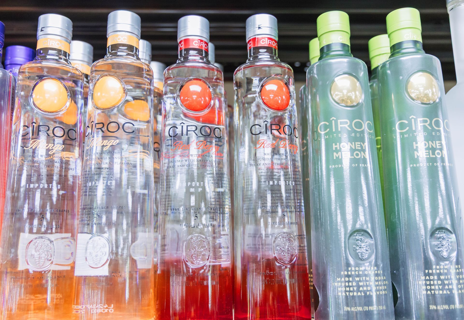 Bottles of Ciroc vodka in different flavors, including orange and honey melon.