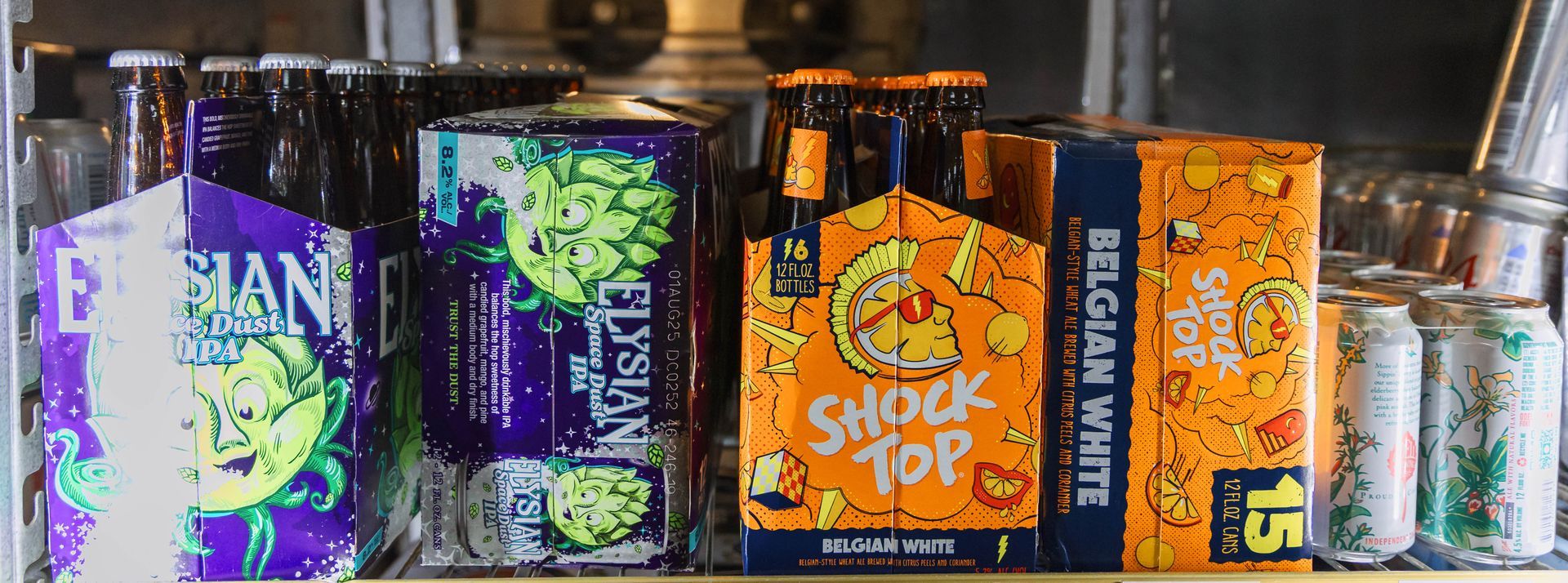 Shelves of beer, including Elysian, Shock Top, and Belgian White brands. Canned and bottled varieties.