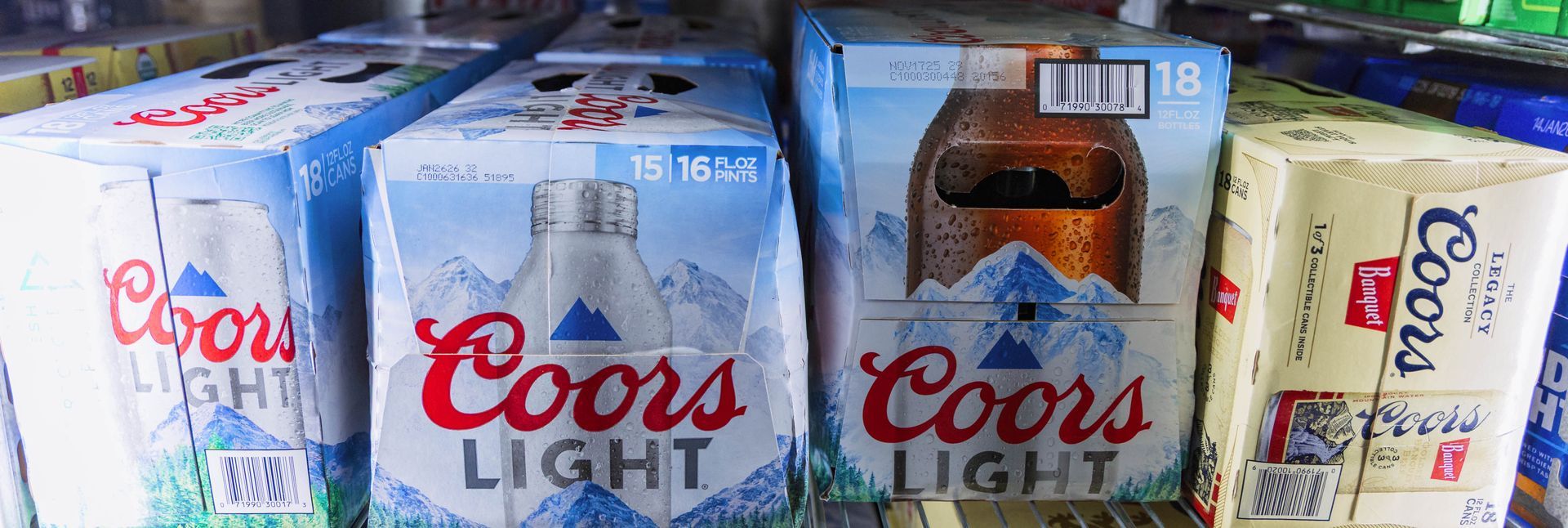 Various boxes of Coors Light beer on a shelf.