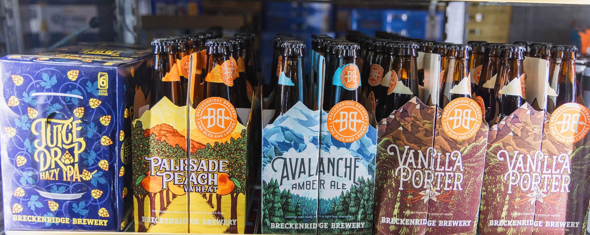 Bottles of beer in a store. Varieties include Ice Drop, Avalanche, and Vanilla Porter.