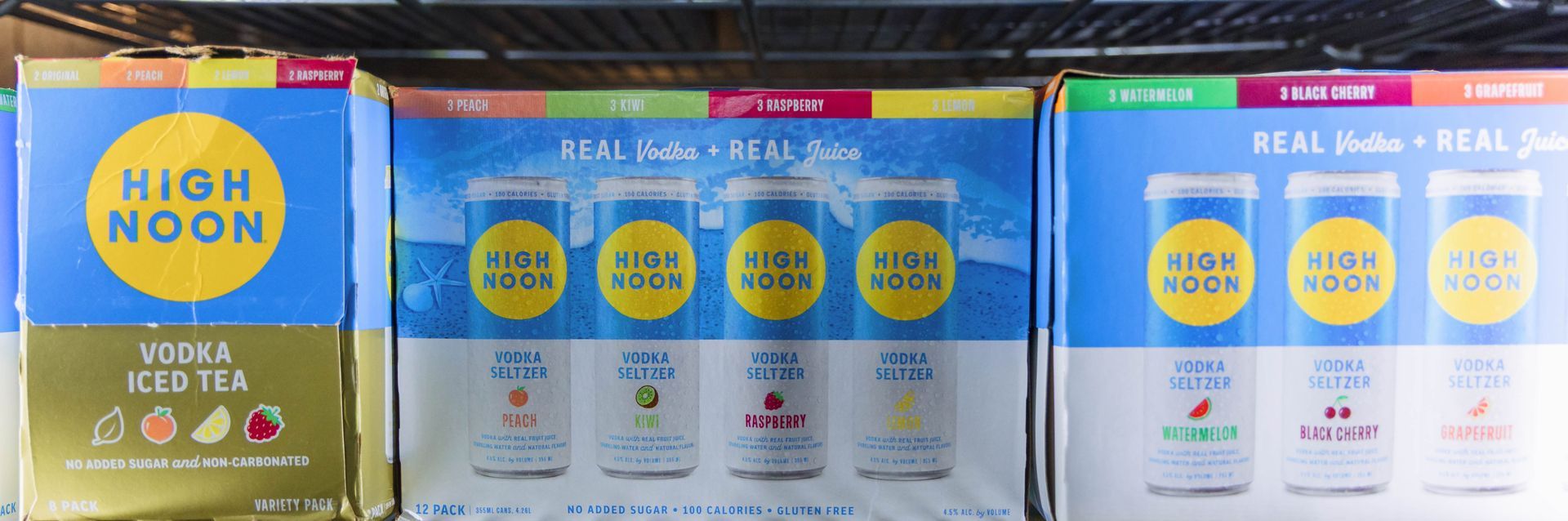 Boxes of High Noon Vodka Seltzers. Flavors include cold tea, peach, lime, grapefruit, and cherry.