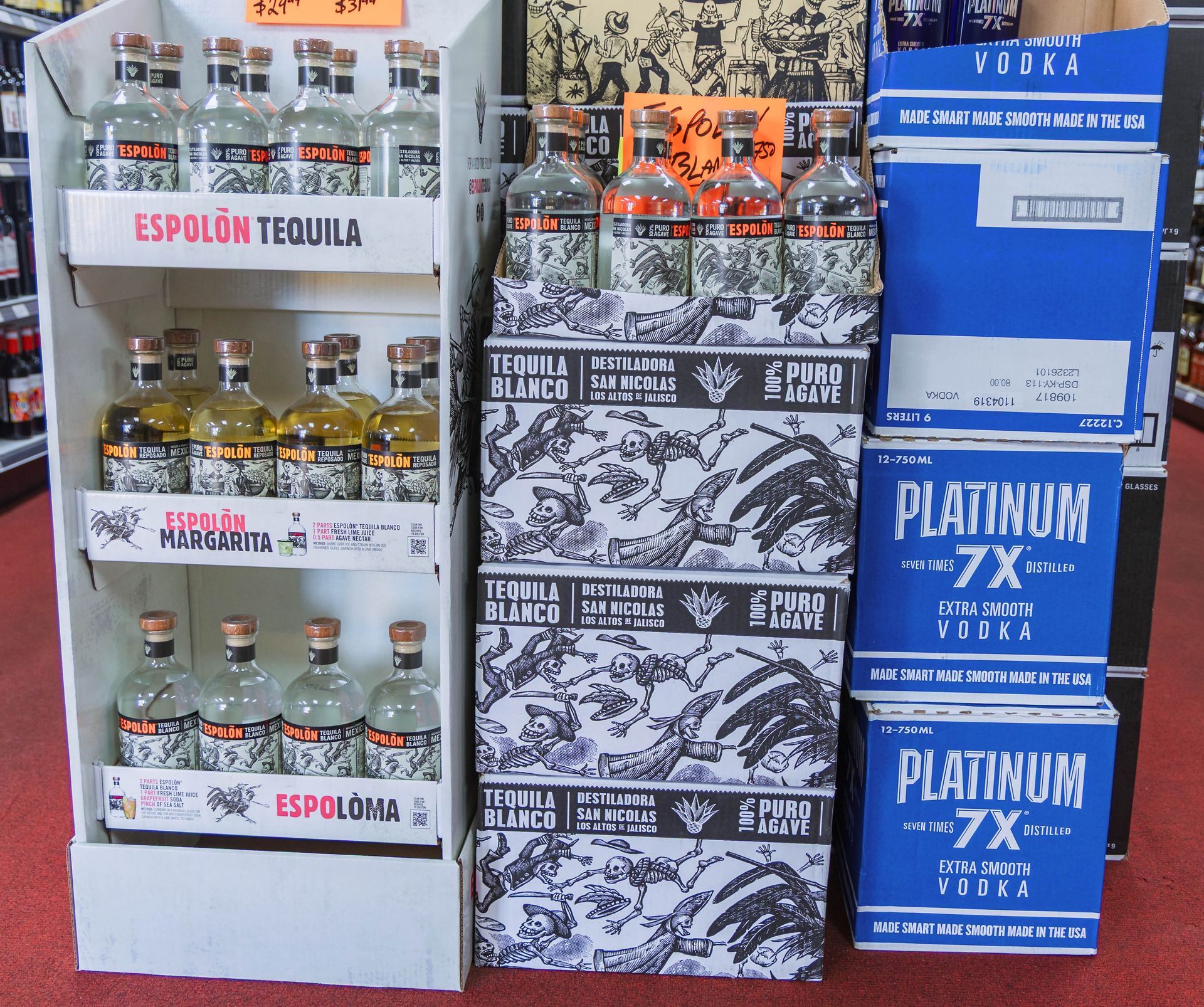 Display of Espolòn Tequila, alongside boxes of vodka, in a liquor store.