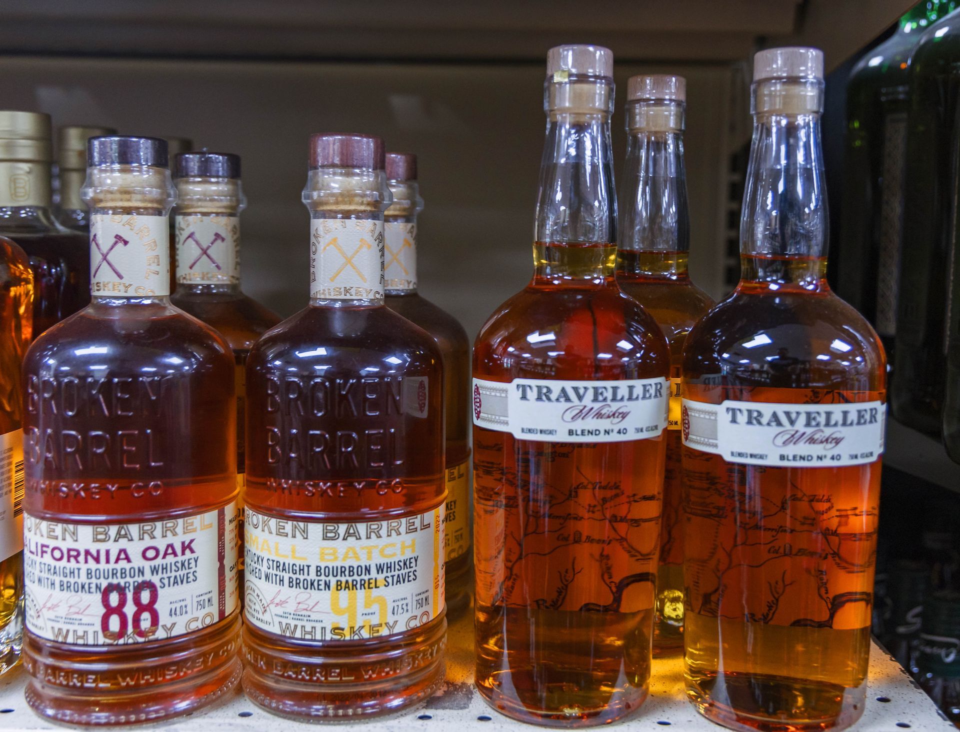 Bottles of liquor on a shelf, including Golden Barrel and Traveller brands.