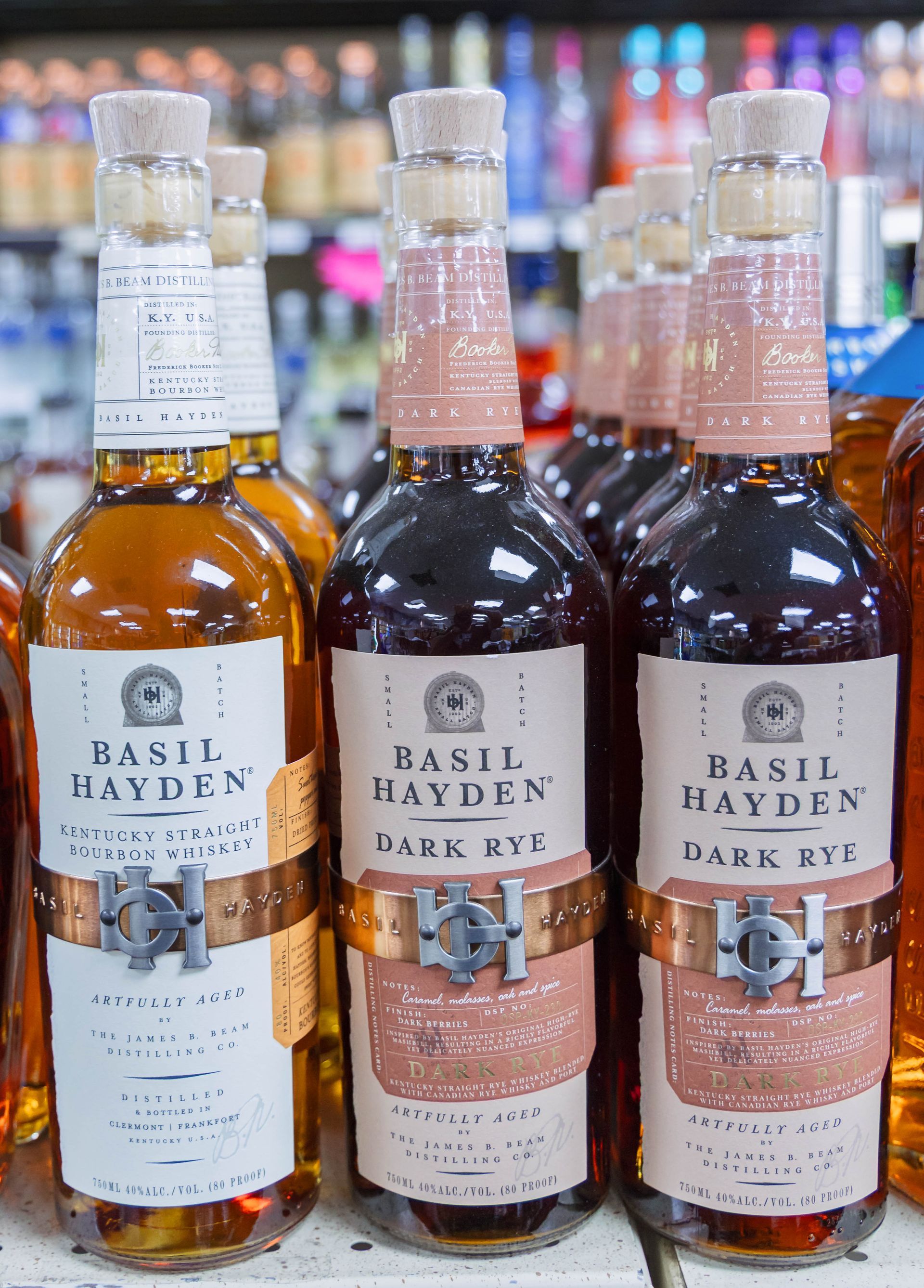 Basil Hayden Dark Rye bottles, brown liquor in glass with tan and copper labels.