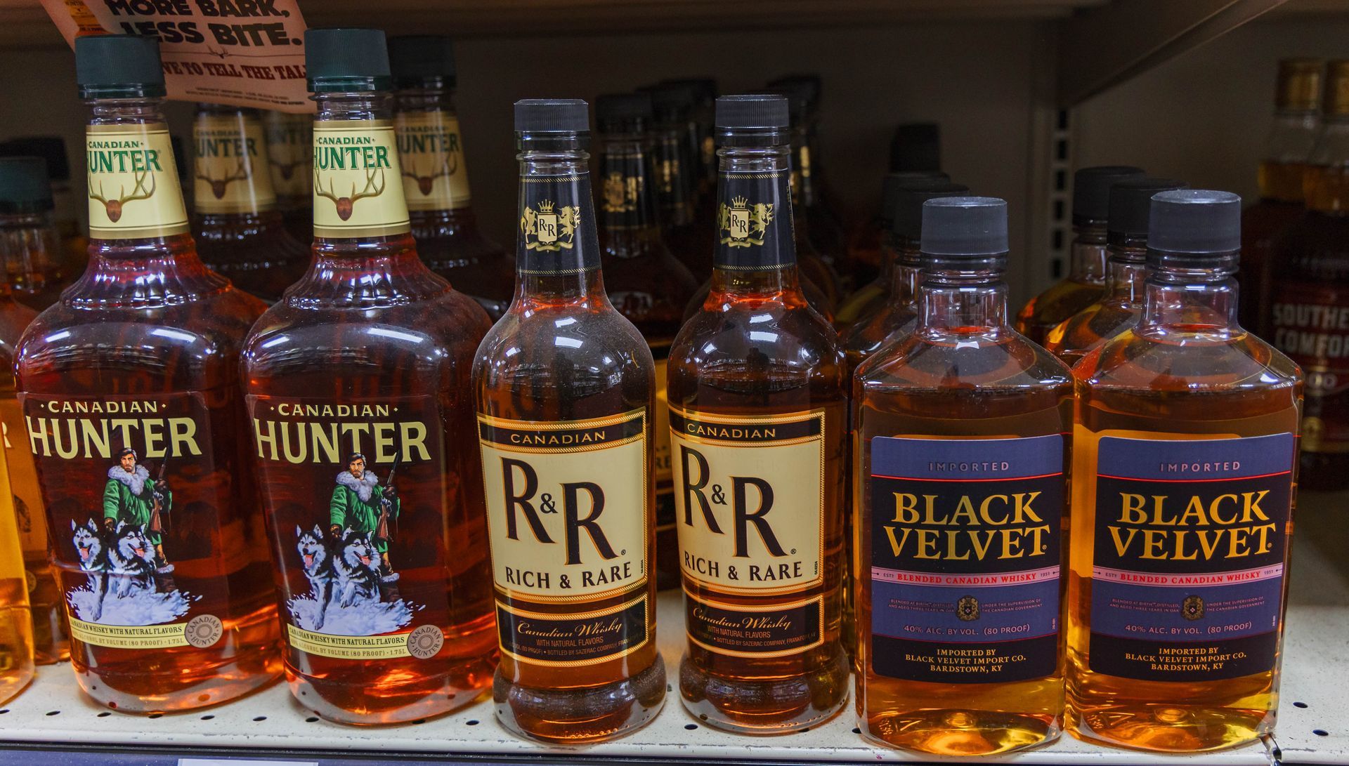Bottles of liquor on a shelf; brands include Canadian Hunter, R&R, and Black Velvet.