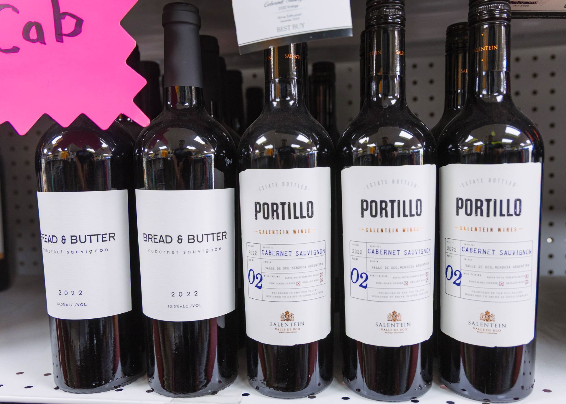 Wine bottles on a shelf: Bread & Butter Cabernet Sauvignon and Portillo Malbec in a shop.