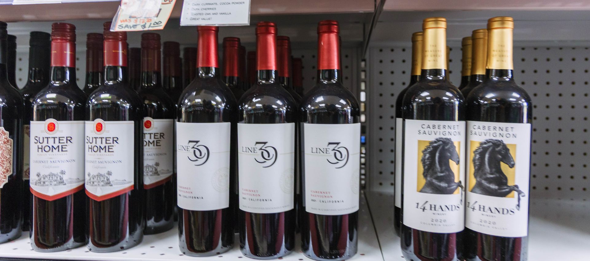 Bottles of red wine on a shelf, including Butterstone and Glass Mountain brands.