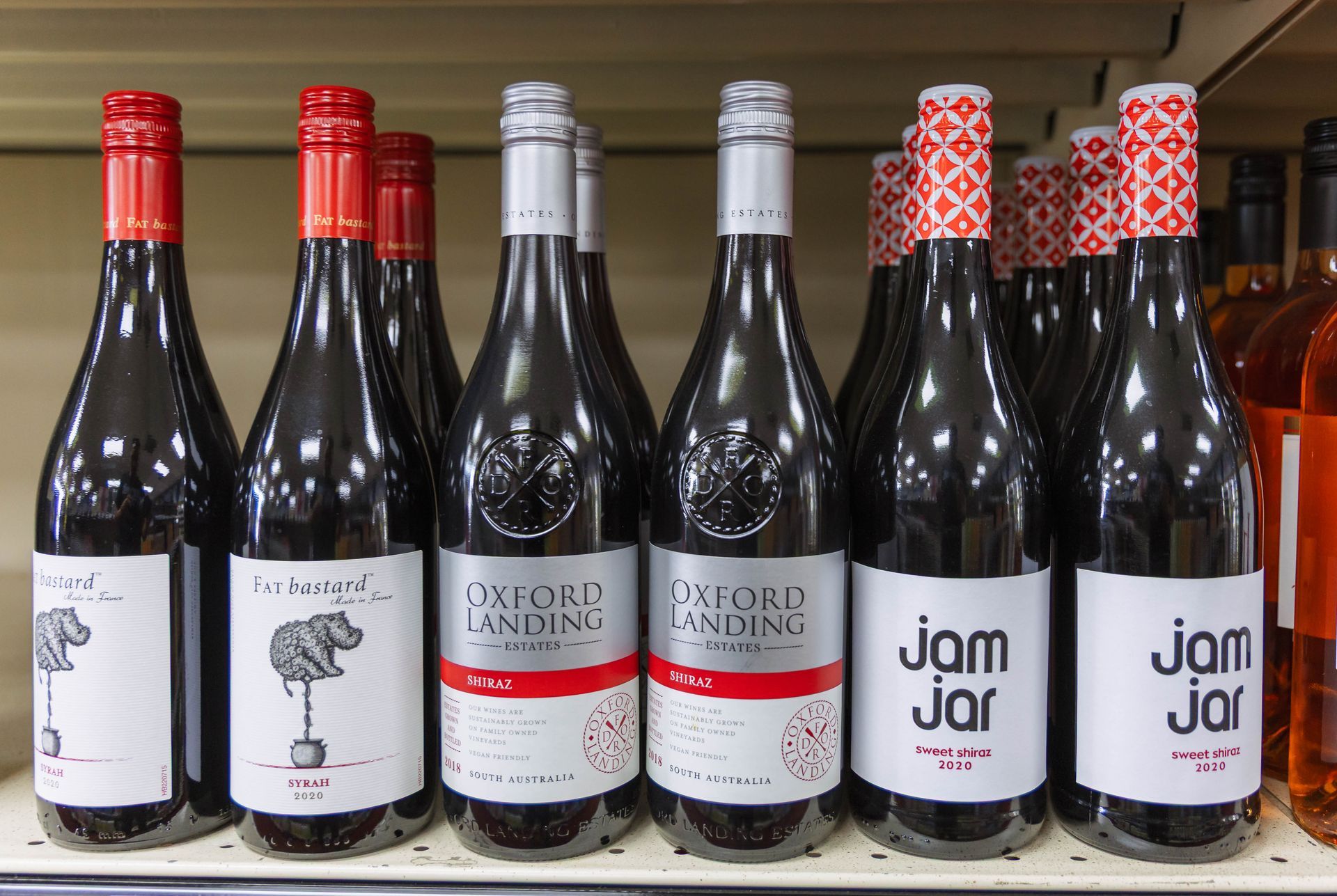 Bottles of wine on a shelf with labels like