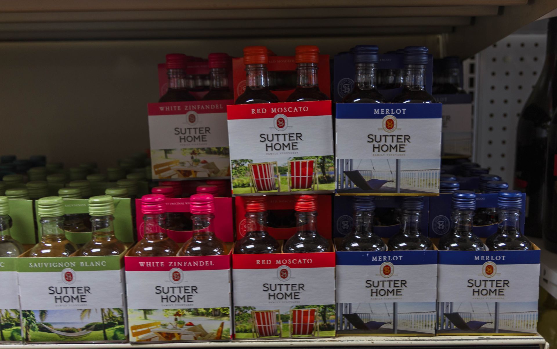 Sutter Home wine boxes in a store display, including white zinfandel, red sangria, and Merlot.