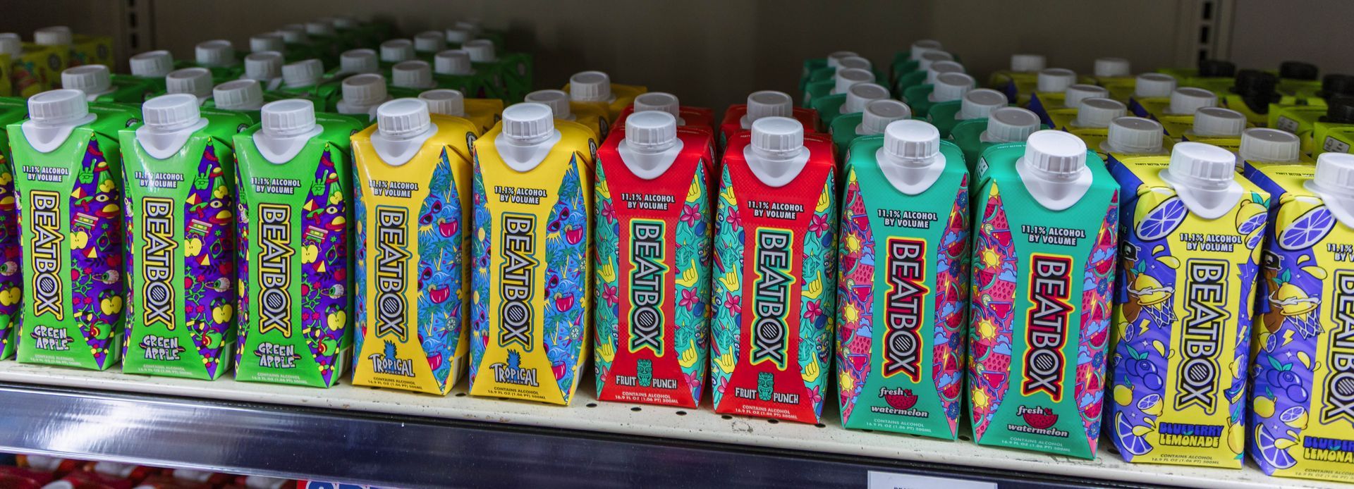 Rows of colorful beverage cartons on a shelf.