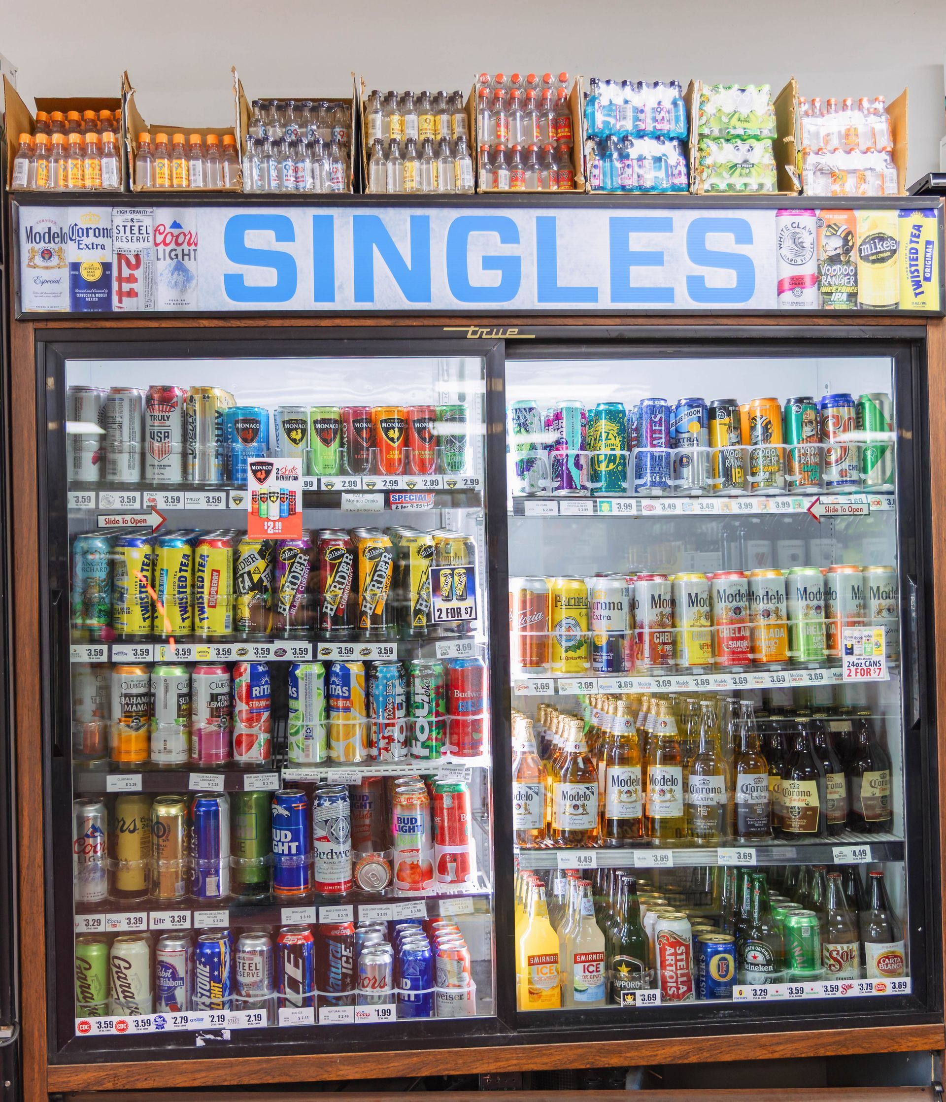 Refrigerator displaying a variety of chilled alcoholic beverages sold as singles in a store.