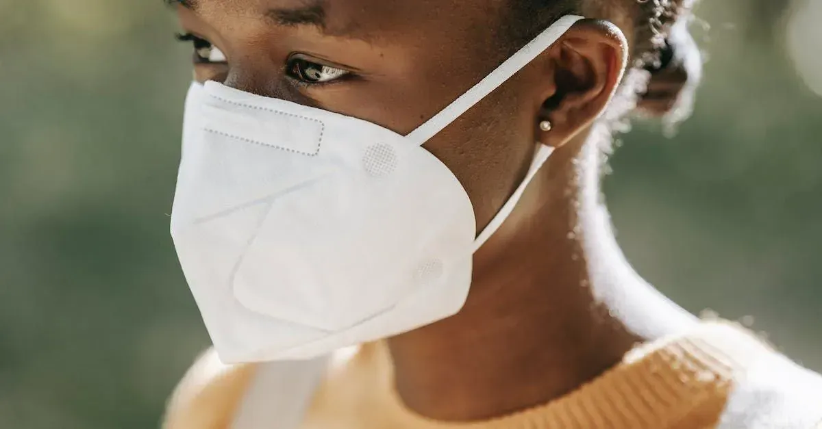 A close up of a person wearing a face mask.