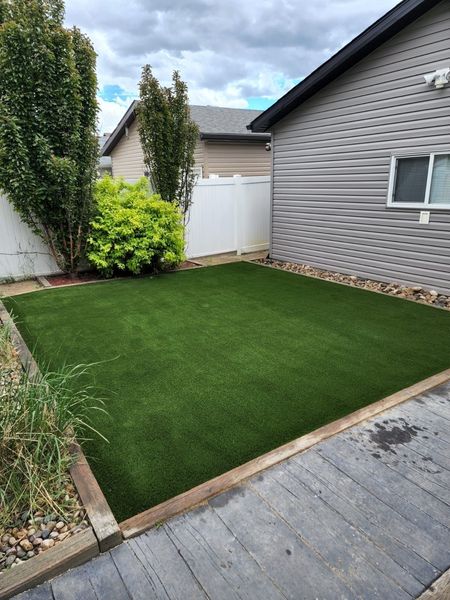 A house with a large lawn in front of it.