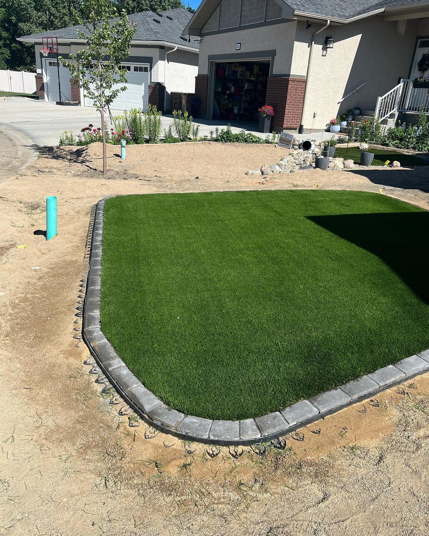 A house with a lush green lawn in front of it.