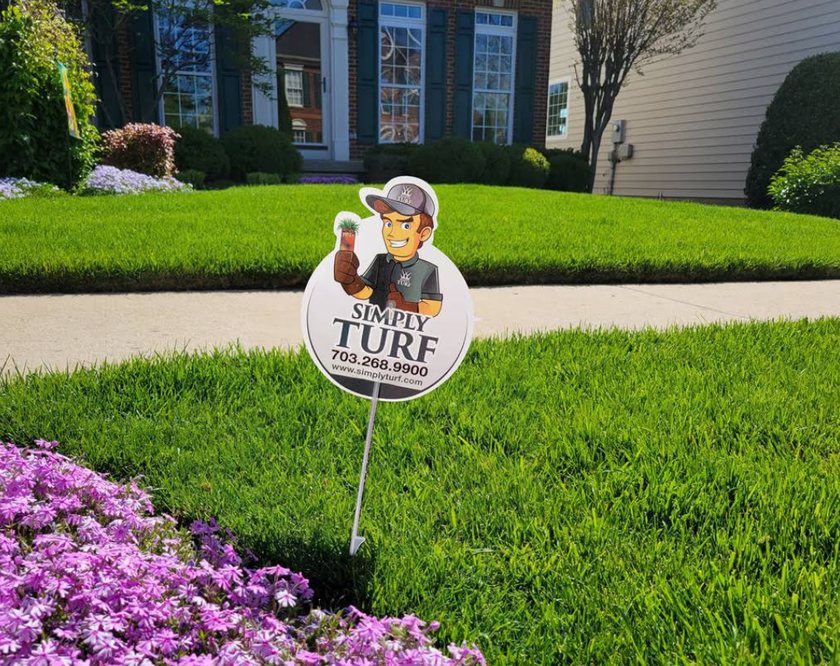 There is a sign in the grass that says `` simply turf ''.